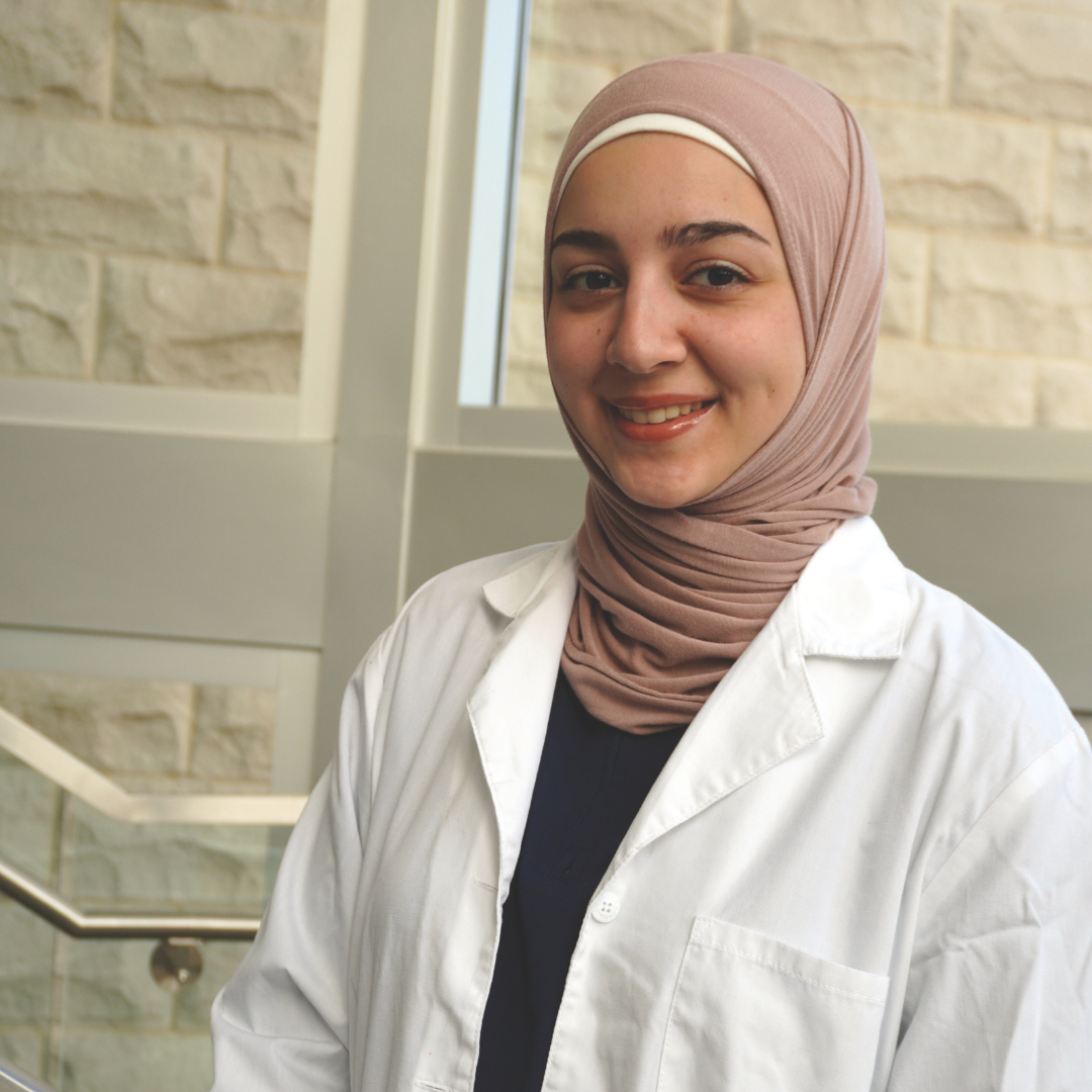 Areej Alfeen in a lab coat. 