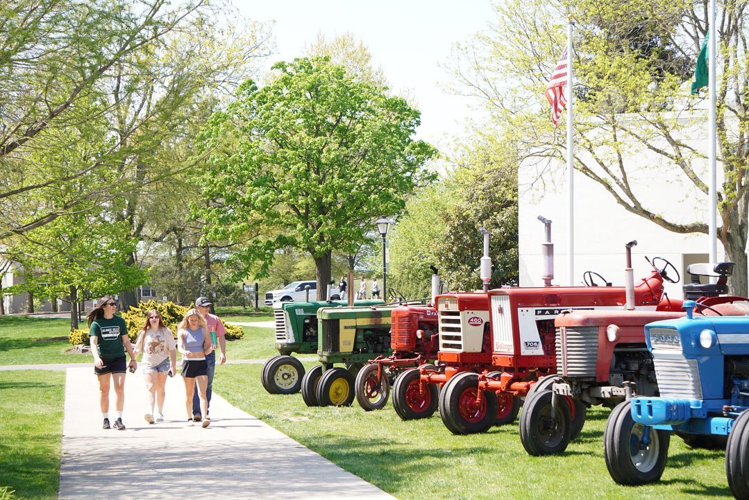 old tractors are lined up side by side at aday. 