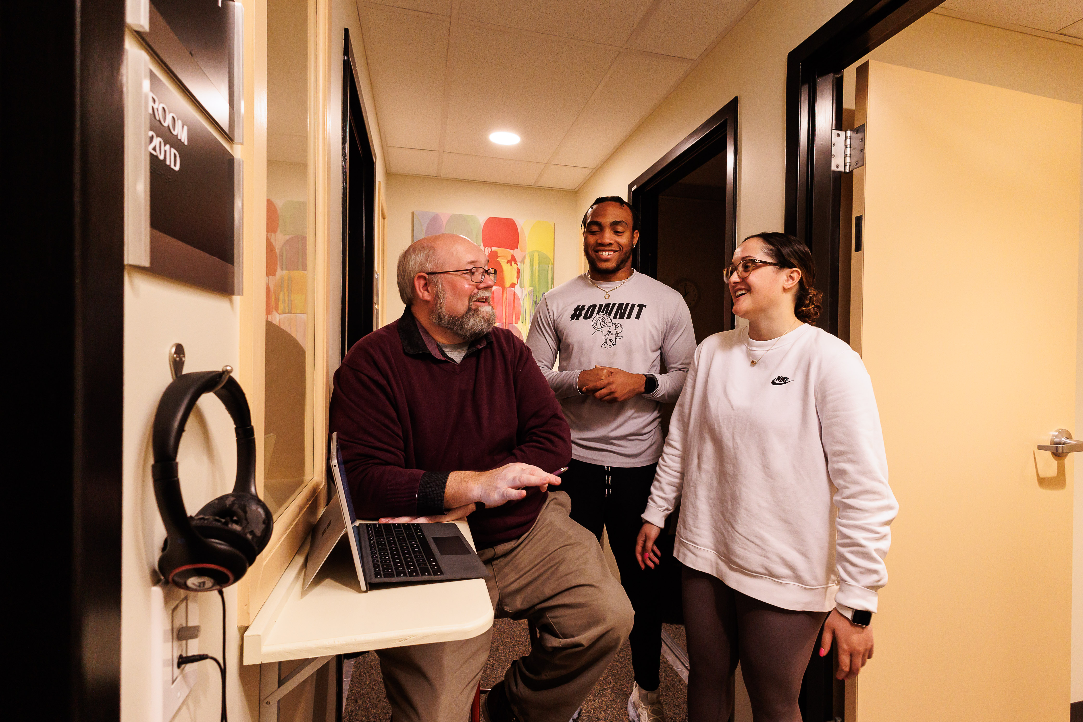 Two counseling psychology students and counseling psychology professor, Matt Mutchler. are in the counseling psychology Lab. 