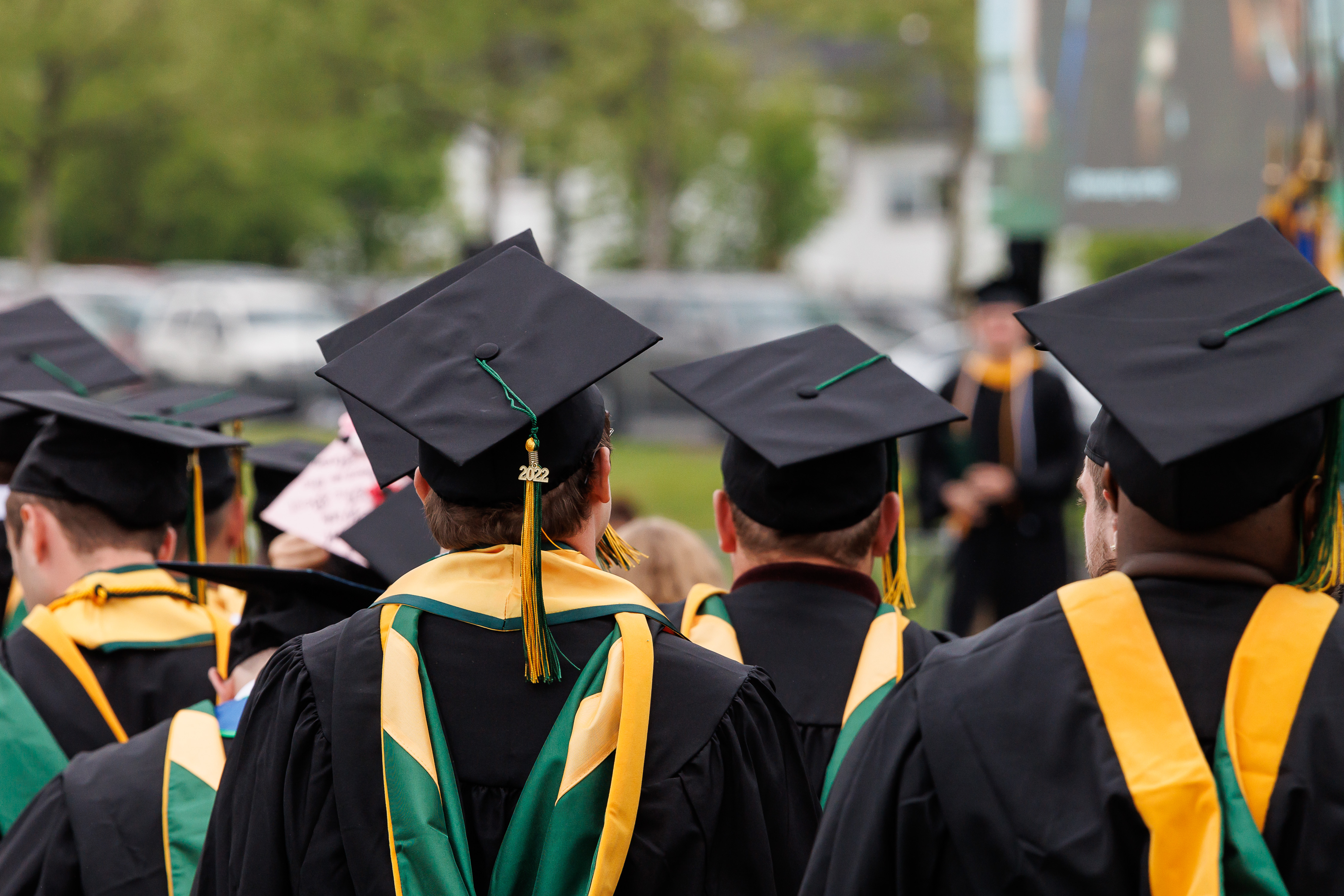 The back of students regalia at commencement.