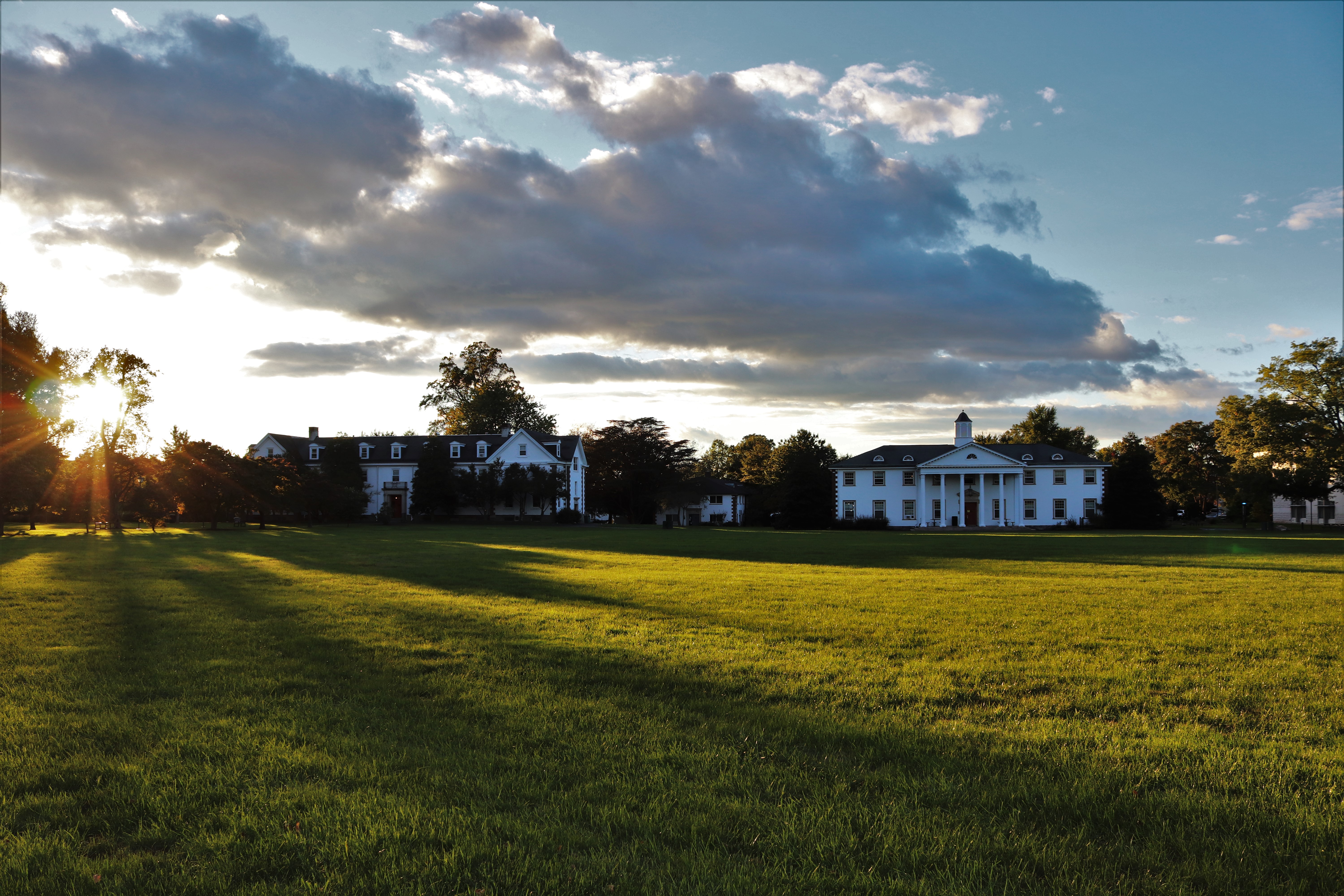 A campus beauty shot of the quad with a view of work hall and ulman hall at sunset.