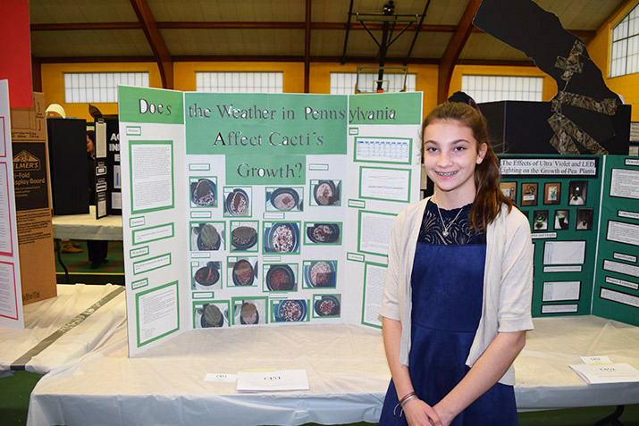 A student presenter with a trifold.