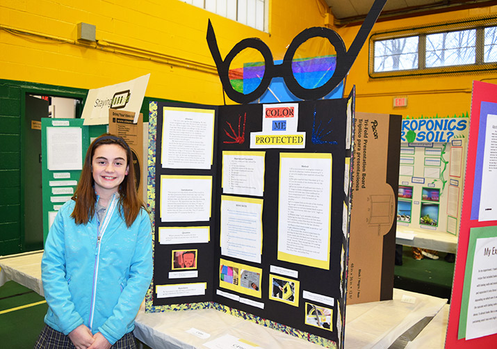 A student with a trifold.