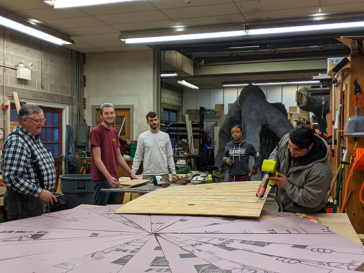 DelVal students and assistant professor Howard Eyre work on the Flower Show exhibit.
