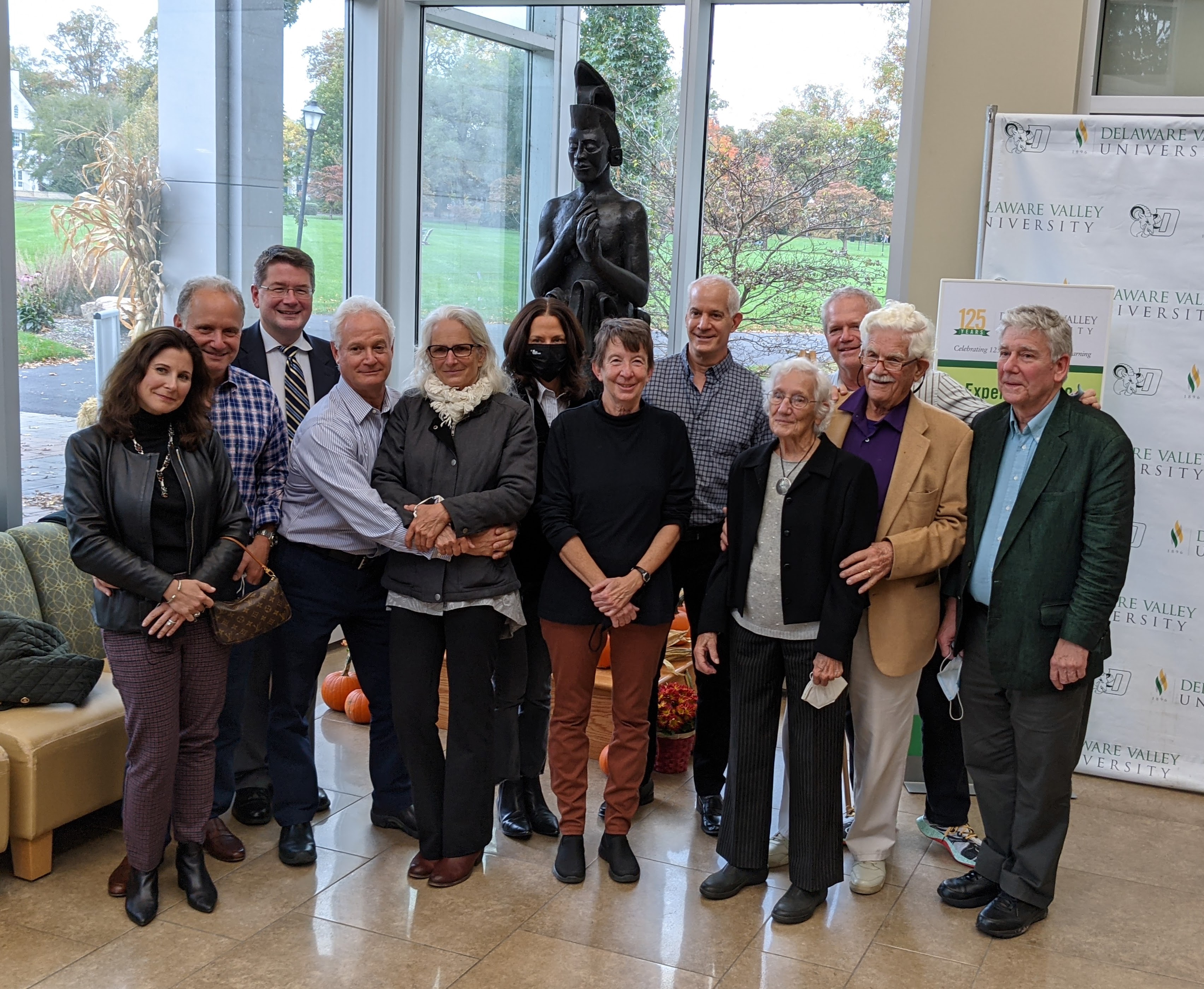 A group of people posing in front of the corn god