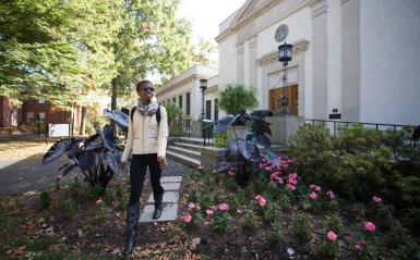 A student walking in front of the library
