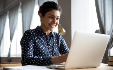 a young woman sitting at a laptop