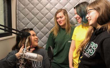 Students standing in the podcast room. 