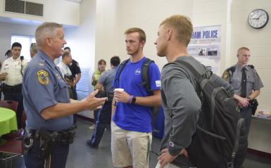 tudents are speaking with a cop during the coffee with a cop event.