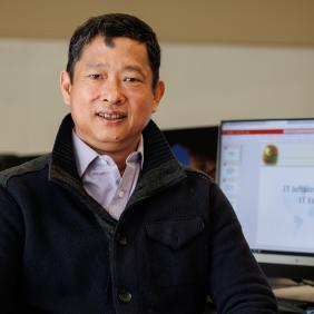 Headshot of Sophea Chea in front of a computer 