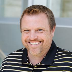 A headshot of Jeff Wehrung with a striped delval collared shirt. 