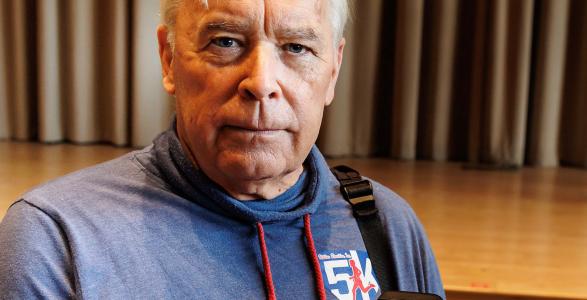 Professor David Beck holding a Phillies ring. 