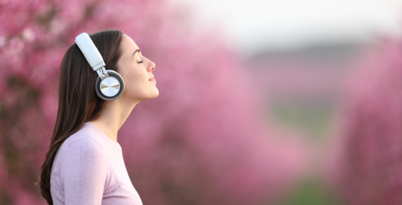 A person is meditating with headphones on. 
