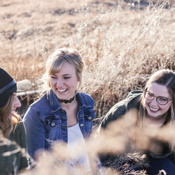 three students in a field