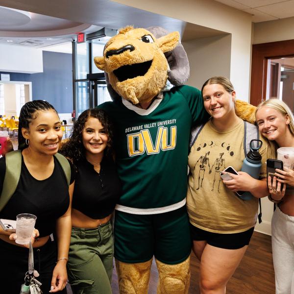 Caesar and 4 students pose at the Starbucks in Levin Dining Hall