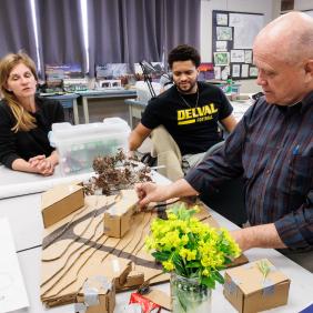 Landscape Architecture students working with a professor in the design studio. 