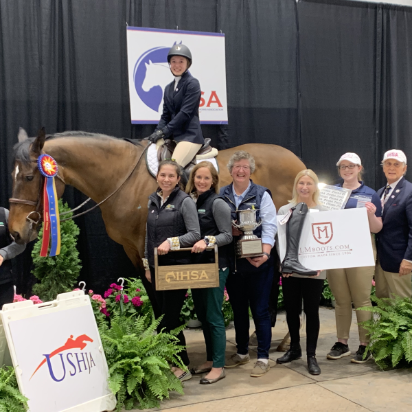 A winning competitor posing with the prize and team