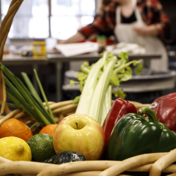 A closeup of fresh fruits and vegetables in a basket. 