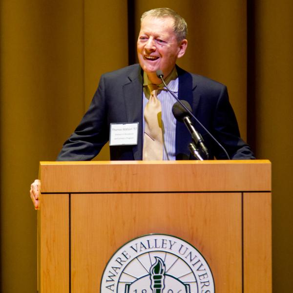 A photo of tom watson at the podium giving a speech. 