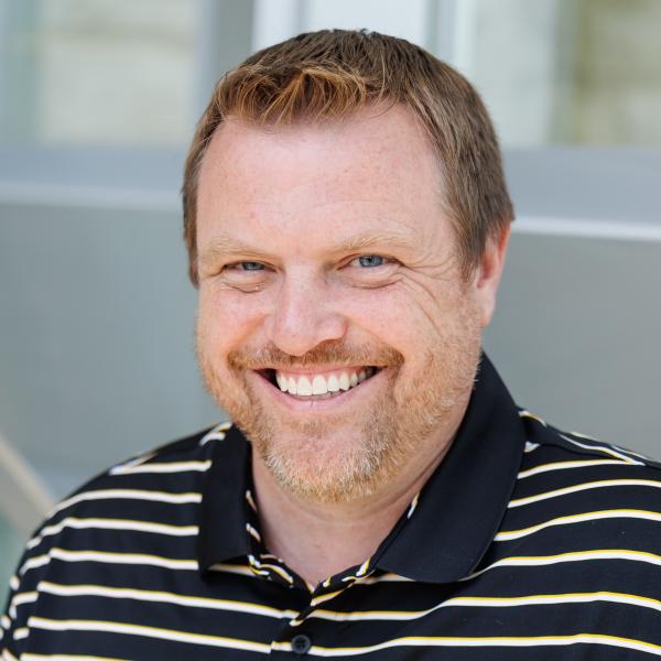 A headshot of Jeff Wehrung with a striped delval collared shirt. 