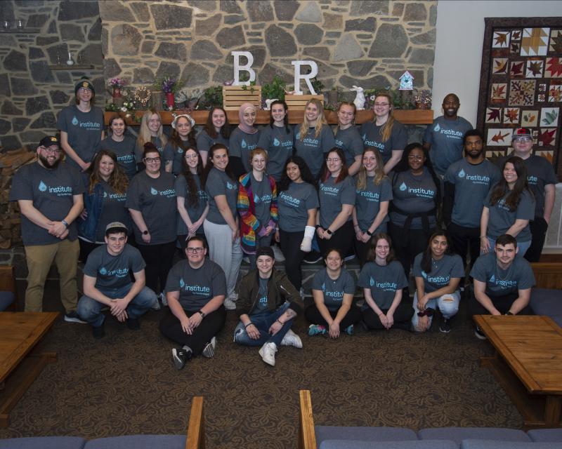 A group of DelVal students wearing LeaderShape T-shirts stand for a group photo. 