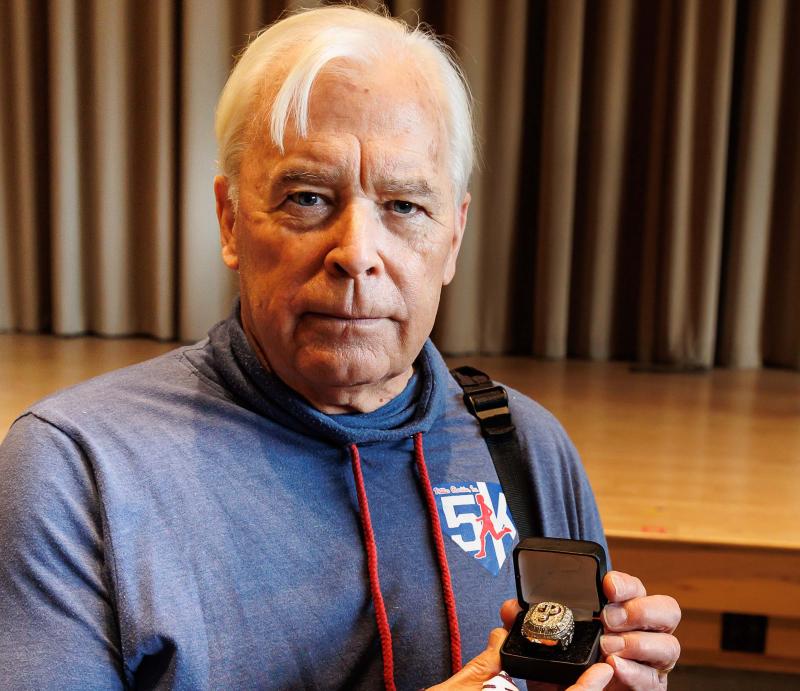 Professor David Beck holding a Phillies ring. 
