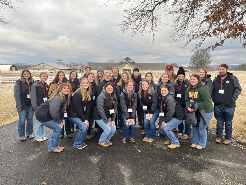 A group photo of all of the students who participated in the NESA competition standing outdoors. 