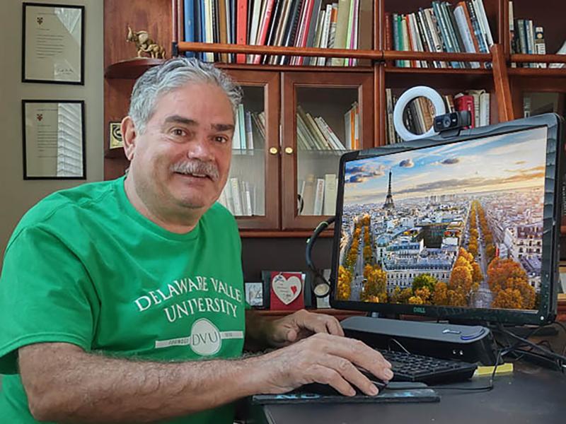 Center for Learning in Retirement Member works at his computer in a hybrid course.
